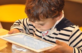 image of boy playing with tablet